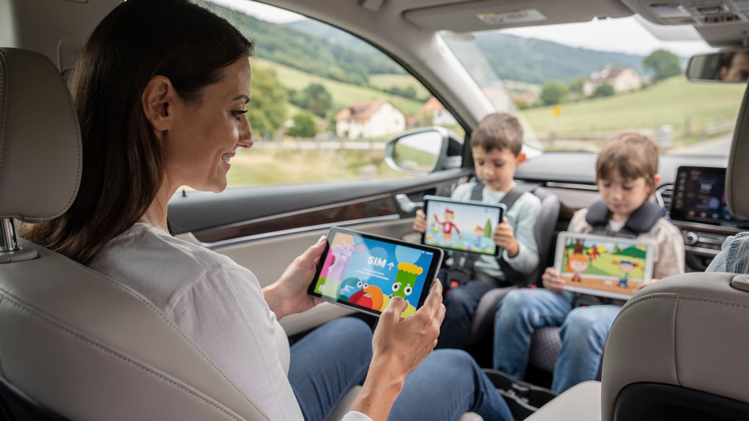 A mother is looking at her phone, which displays an eSIM activation screen, while her two children are engaged with their tablets in the backseat of a car, travelling through a scenic European countryside.