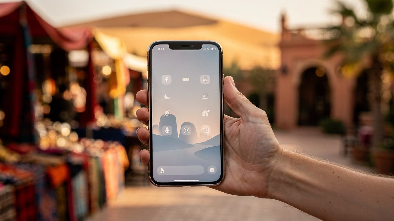 A modern smartphone held against a vibrant, sun-drenched Moroccan background, evoking seamless travel and easy connectivity without any visible text or logos.