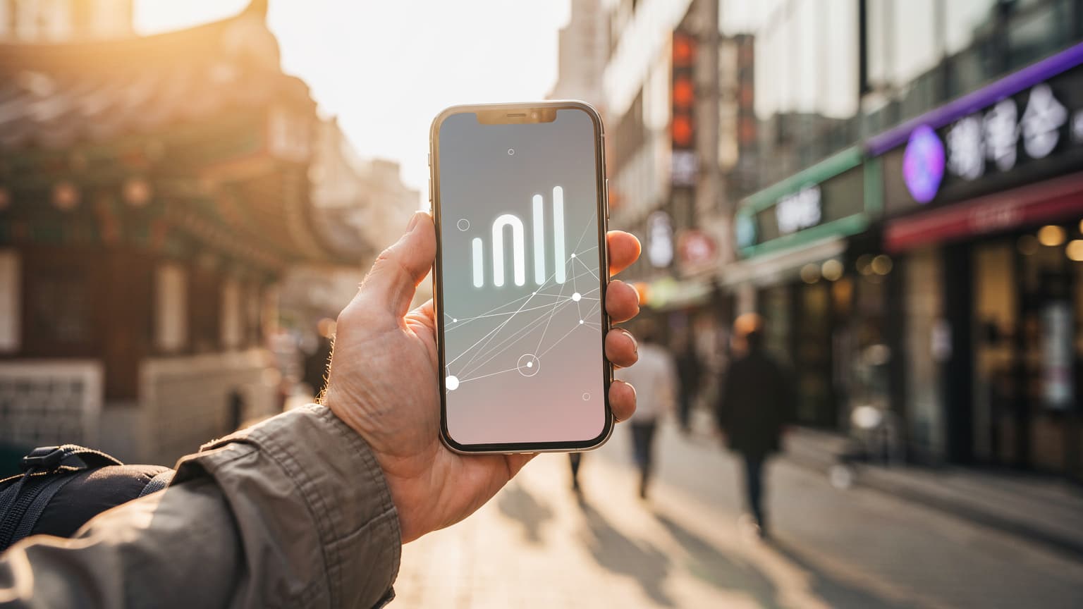 A close-up of a hand holding a smartphone with a digital interface, set against a blurred background of a bustling Korean city street, symbolizing smart travel connectivity.