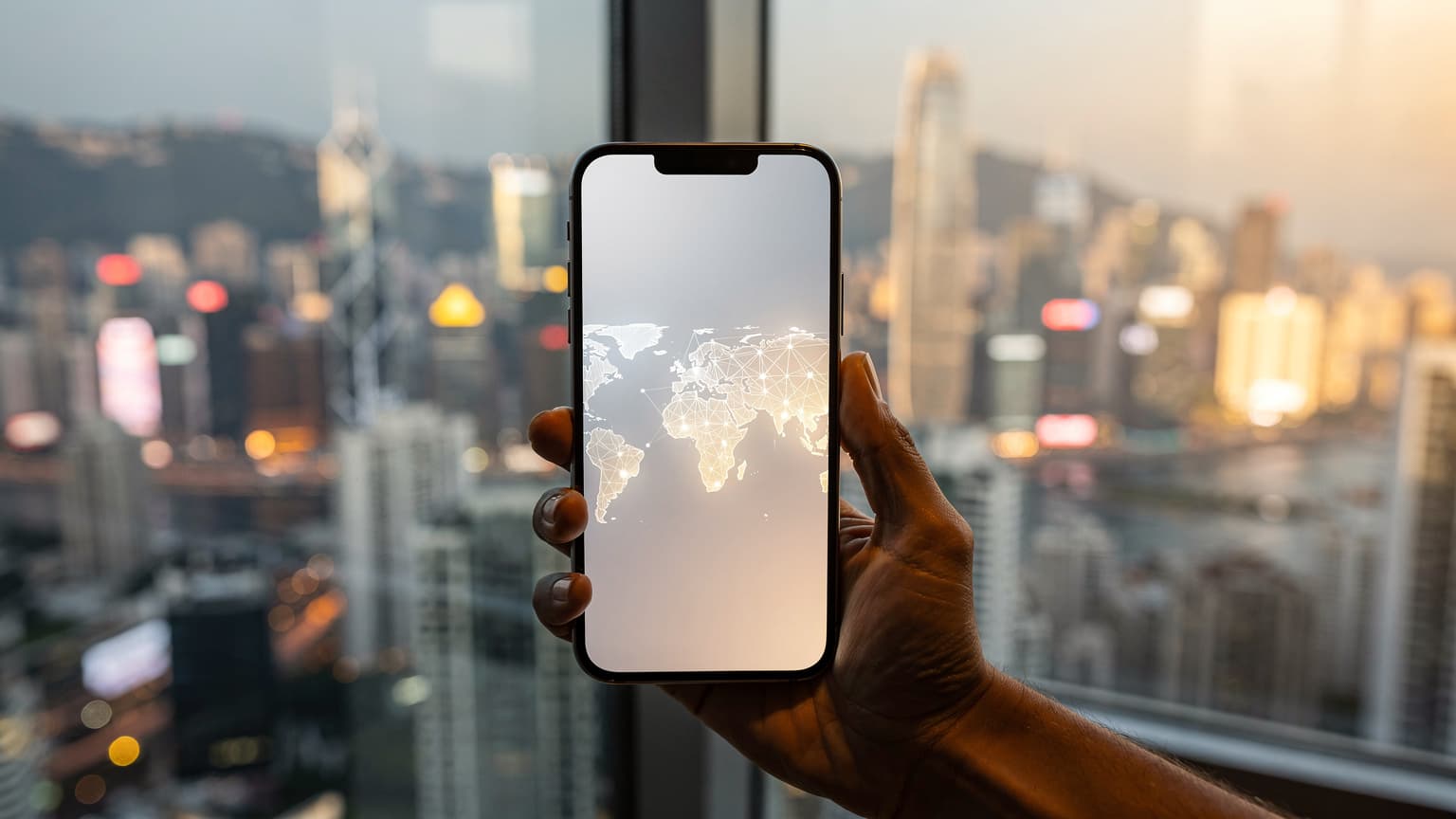 A hand holds a modern smartphone with a glowing, abstract screen, set against a blurred, vibrant East Asian cityscape at dusk, symbolizing global travel and eSIM connectivity.