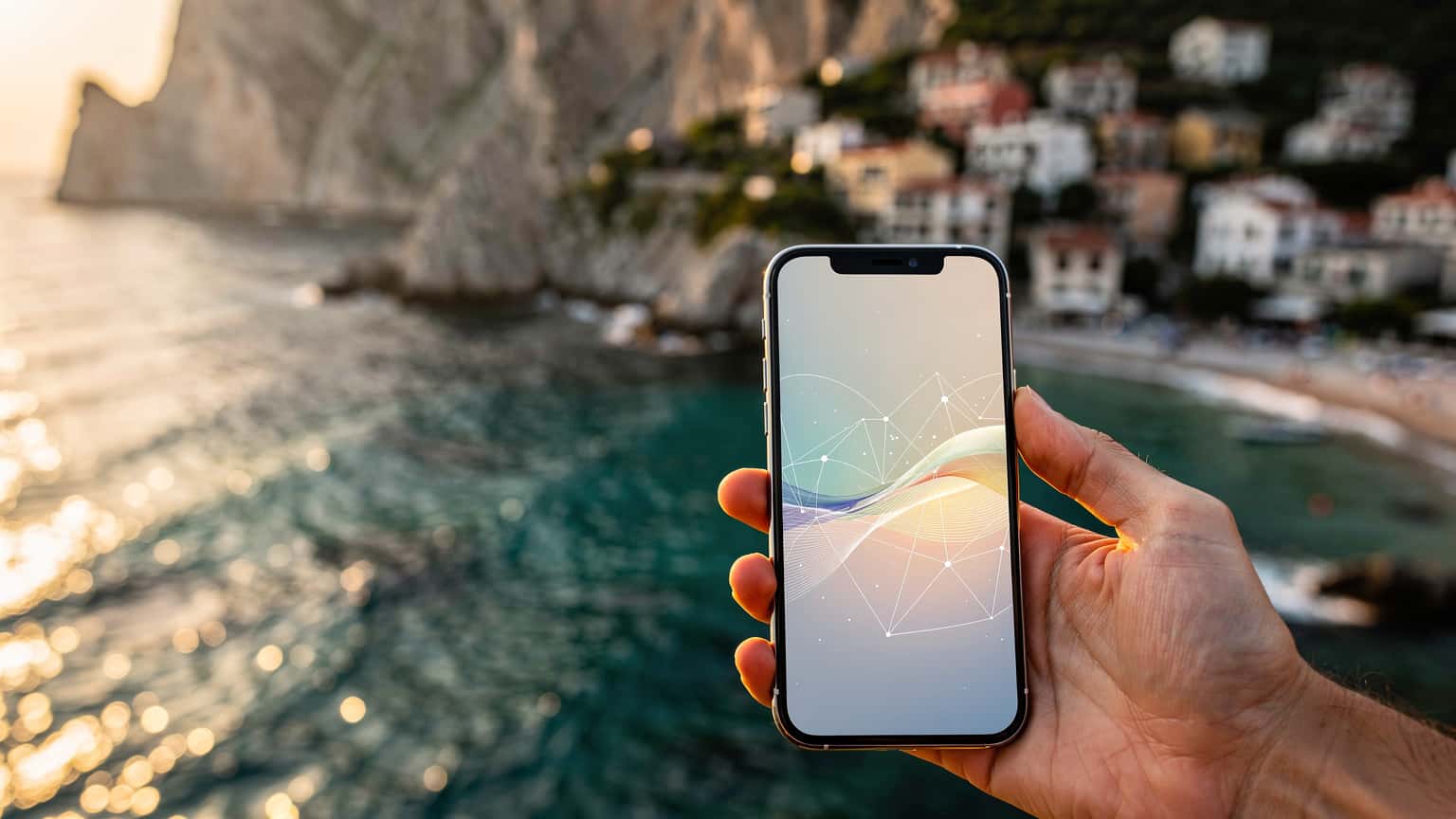 A modern smartphone held against a sunlit, blurred backdrop of the Albanian Riviera, symbolizing seamless travel data.